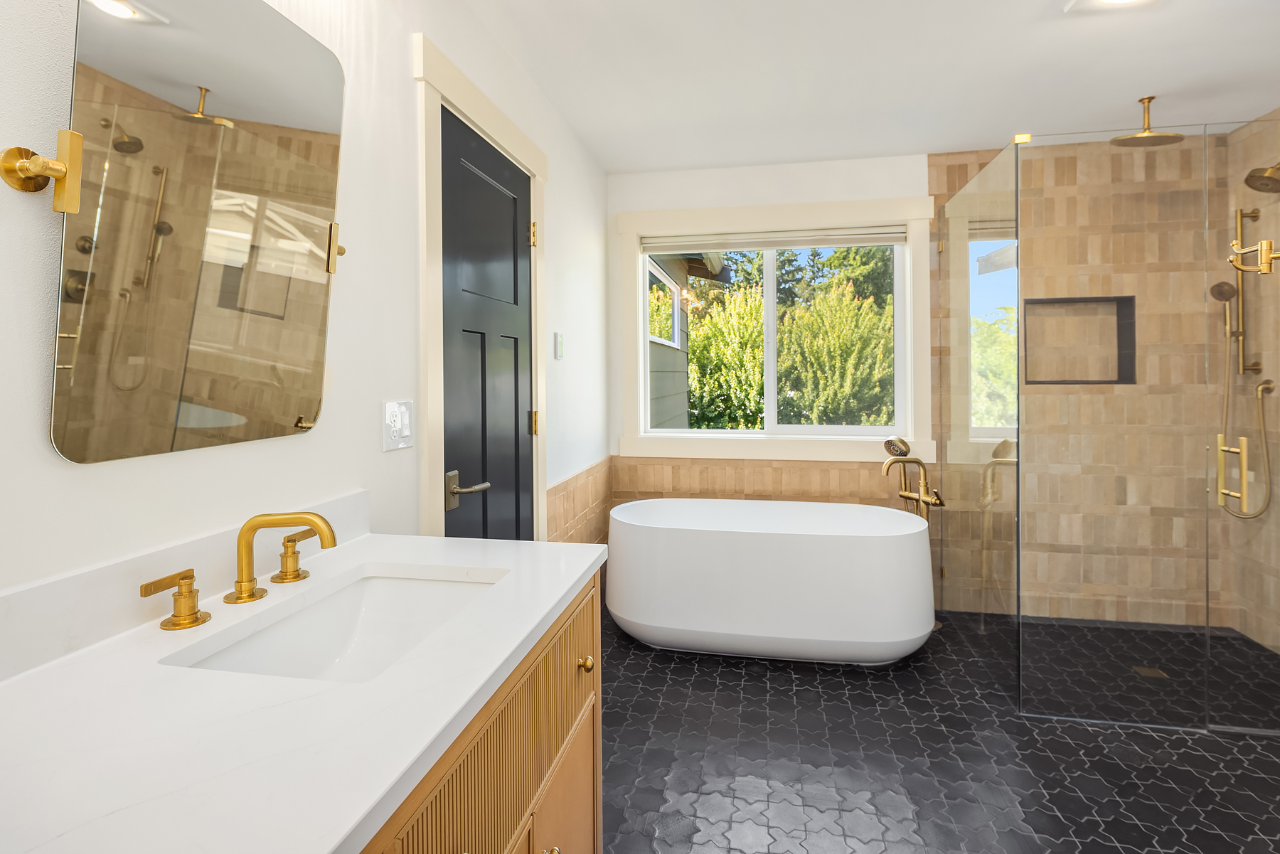 Primary bath with soaking tub, glass shower and brass fixtures