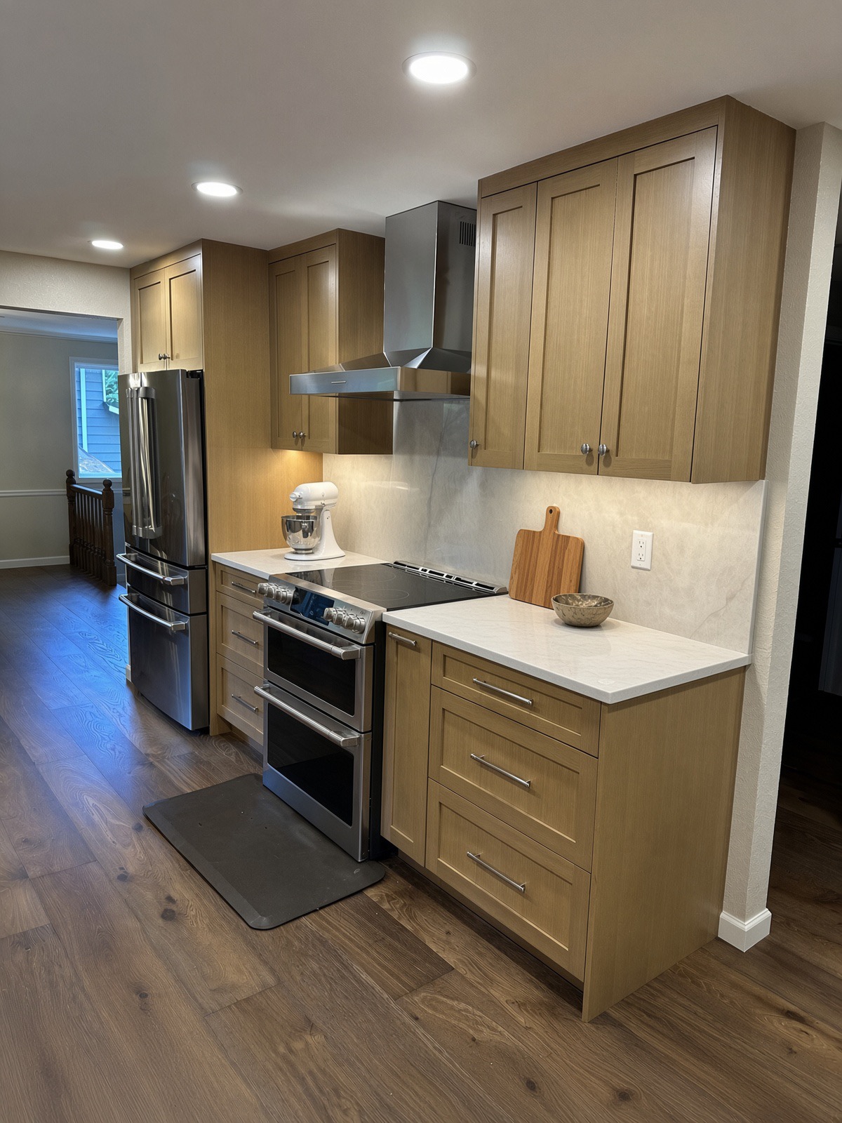 Bothell kitchen range wall with white oak cabinetry and quartz backsplash