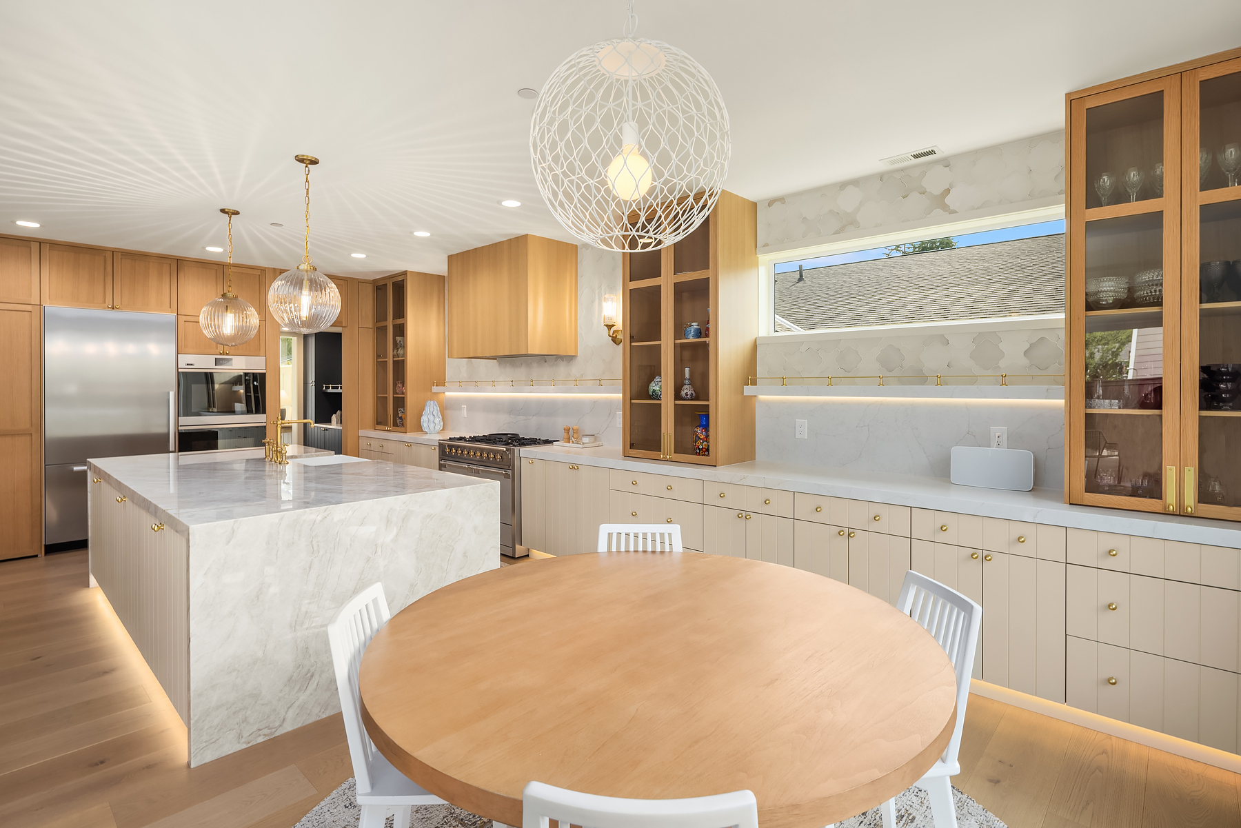 Kitchen and breakfast dining area with round oak table