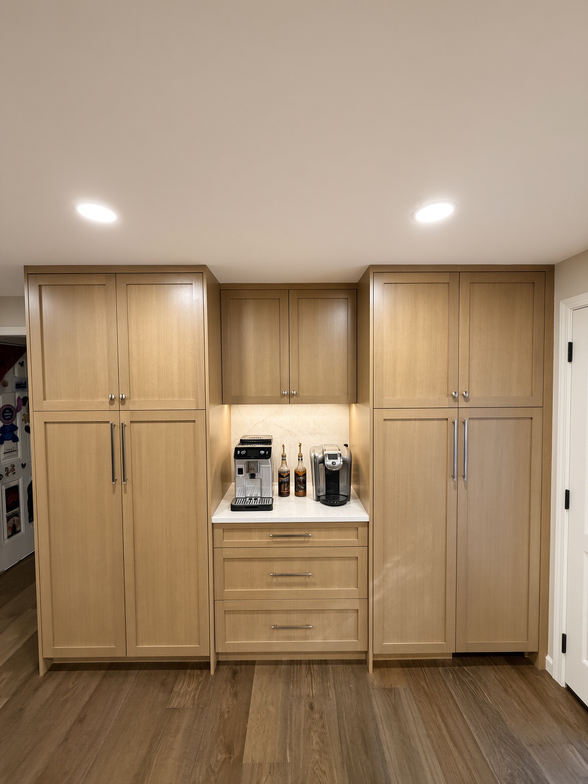 Built-in Bothell coffee station centered between tall white oak pantry cabinets