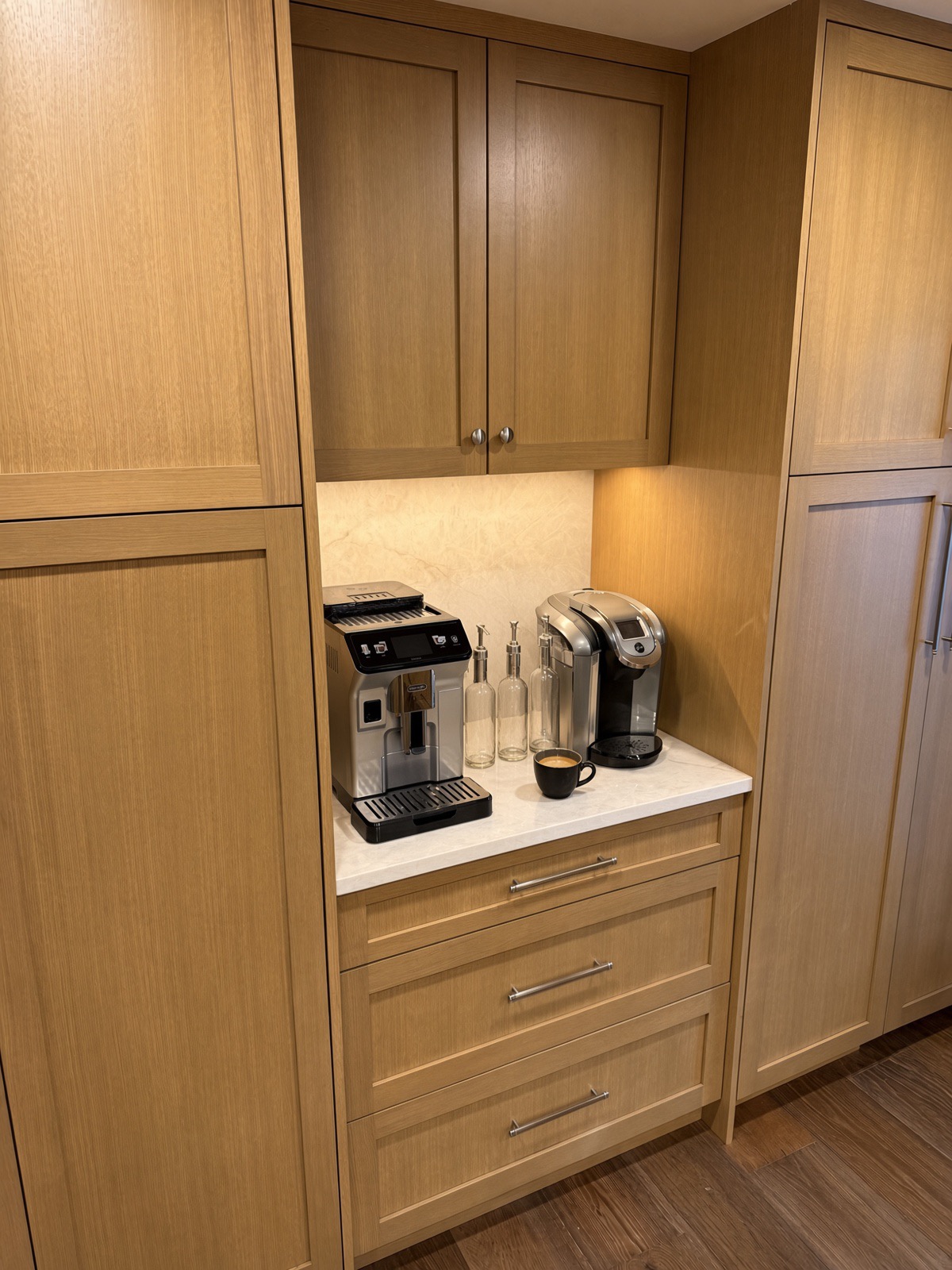 Close-up of the built-in coffee niche with undercabinet lighting